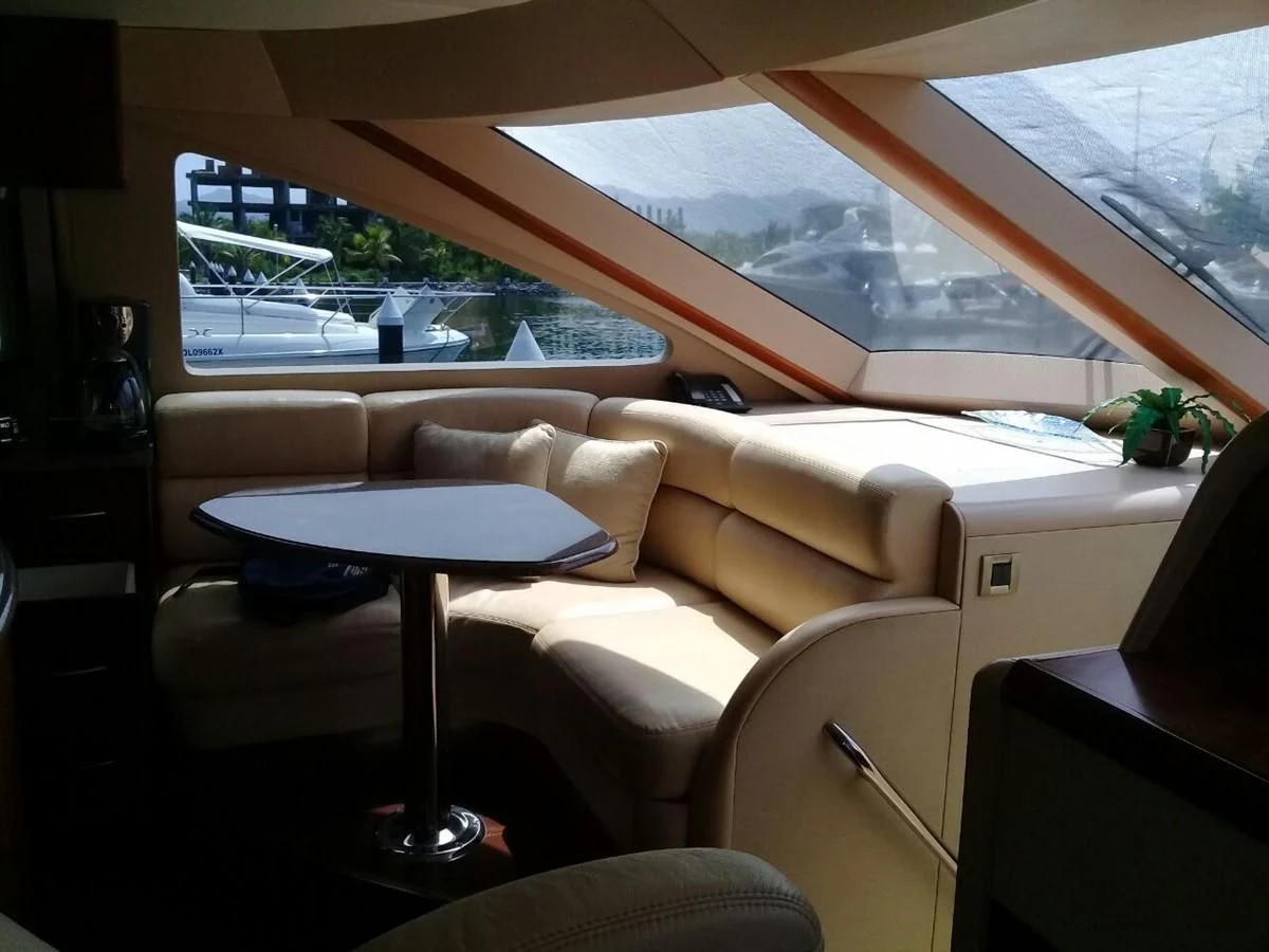 a living room with a large window aboard LAZZARA 68' Yacht for Sale