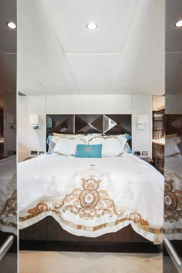 a bed with a pillow and a headboard aboard LAZZARA 68' Yacht for Sale