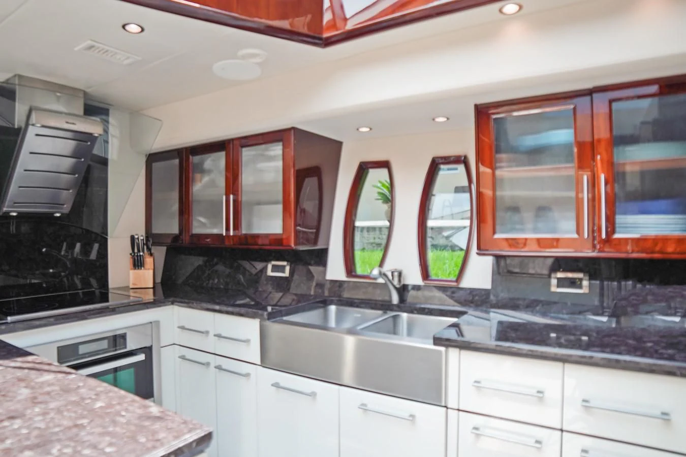 a kitchen with wooden cabinets aboard LAZZARA 68' Yacht for Sale