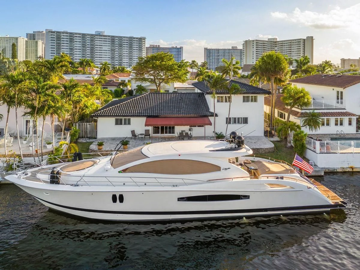 a white boat on a beach aboard LAZZARA 68' Yacht for Sale
