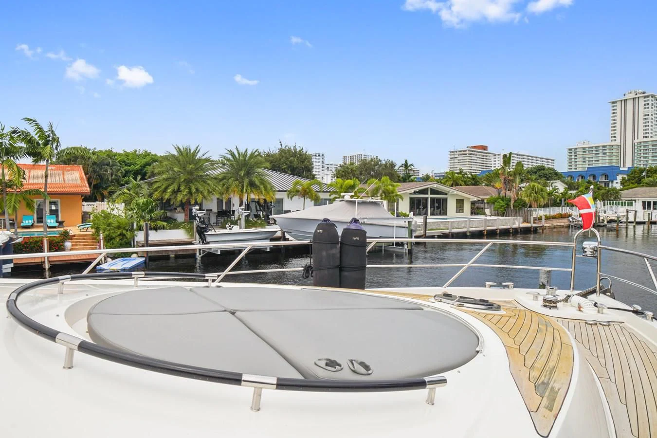 a pool with a large pool and buildings in the background aboard LAZZARA 68' Yacht for Sale