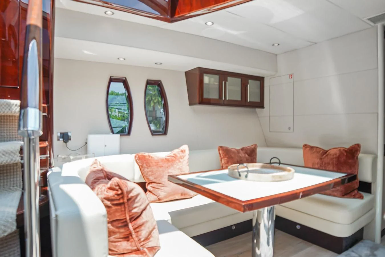 a living room with a table and chairs aboard LAZZARA 68' Yacht for Sale
