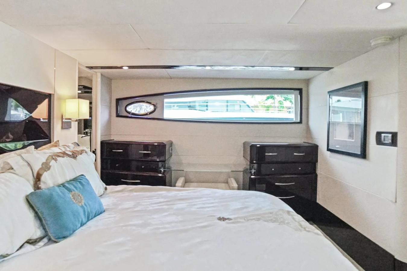a bedroom with a large bed and a flat screen tv aboard LAZZARA 68' Yacht for Sale