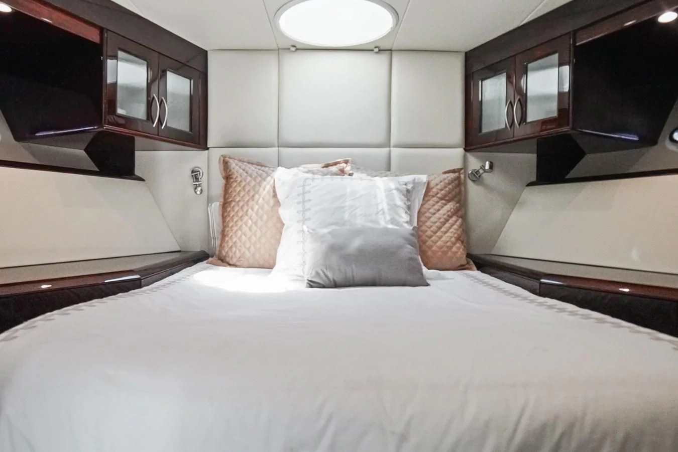 a bed with pillows aboard LAZZARA 68' Yacht for Sale