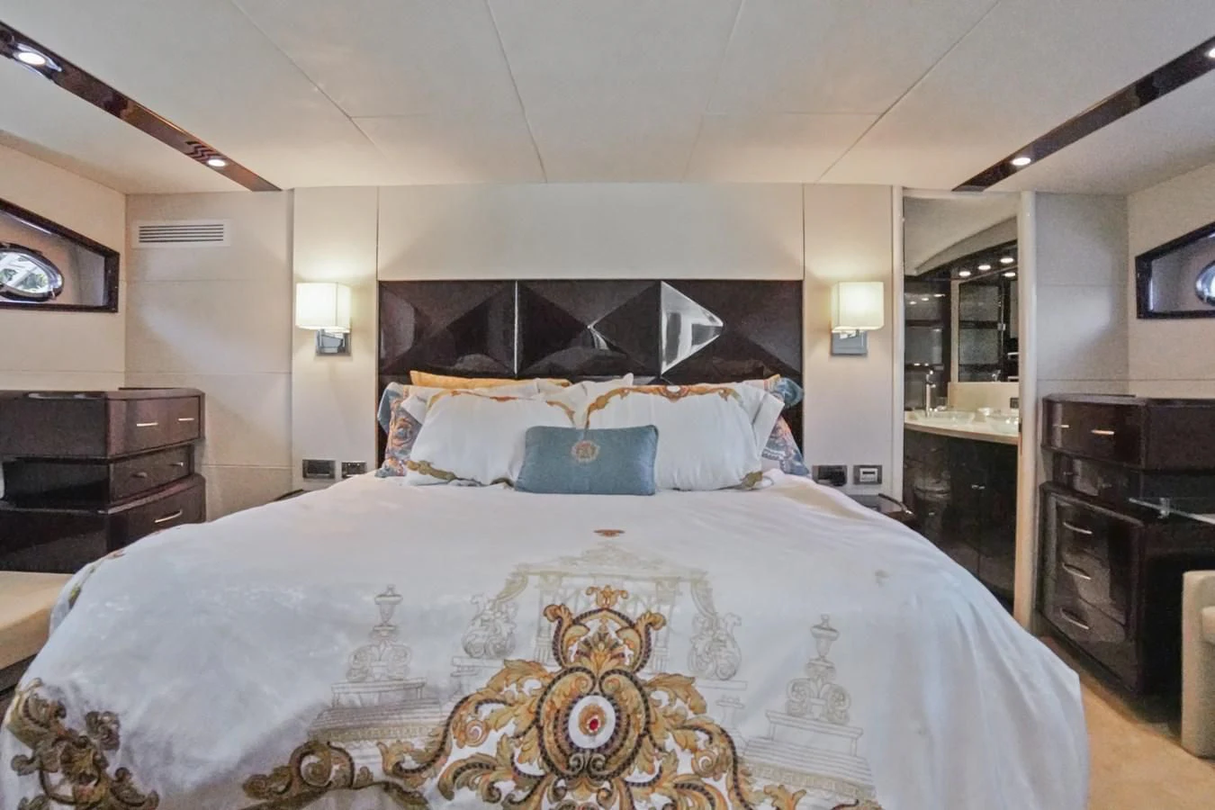 a bedroom with a large bed aboard LAZZARA 68' Yacht for Sale