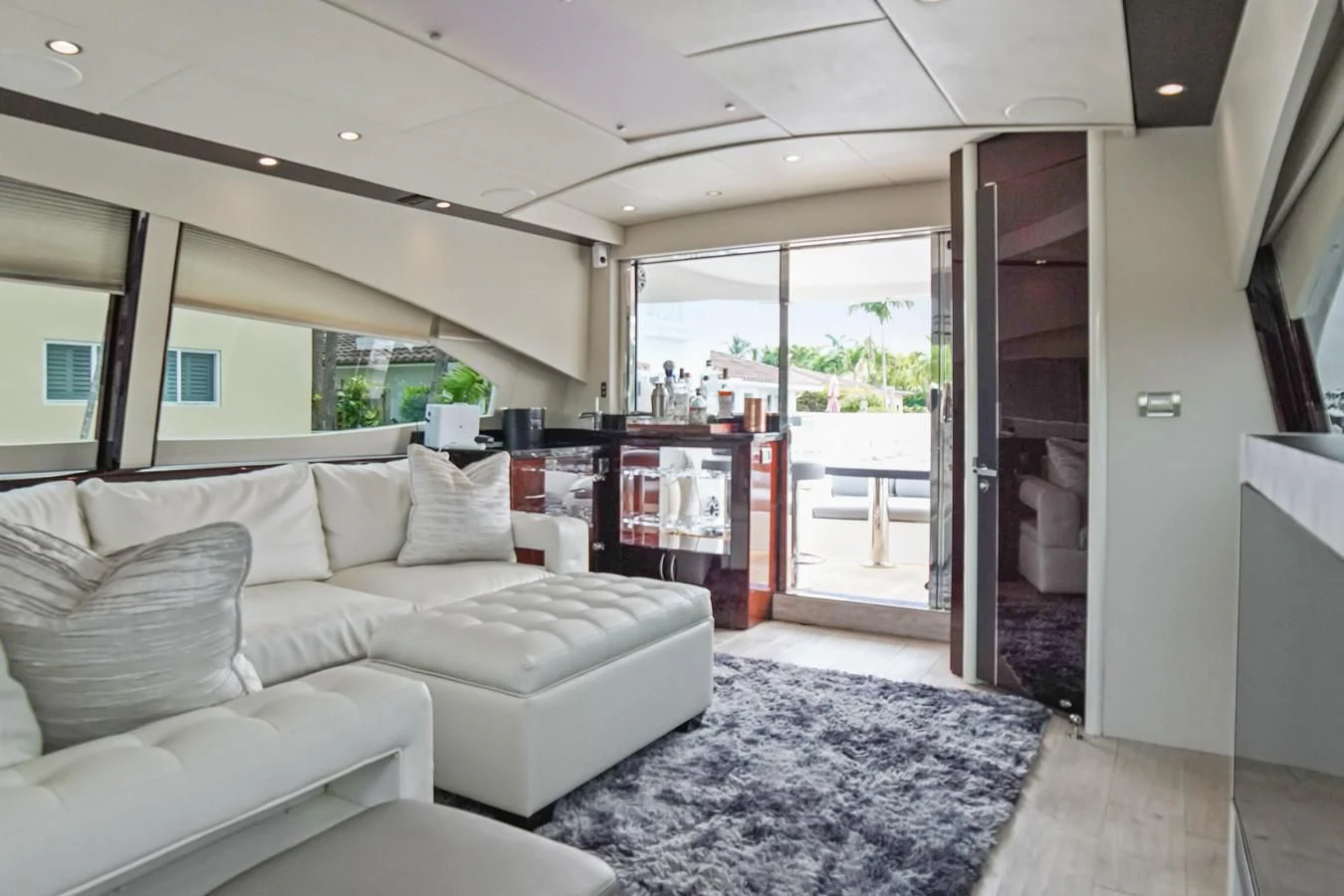 a living room with a large glass door aboard LAZZARA 68' Yacht for Sale