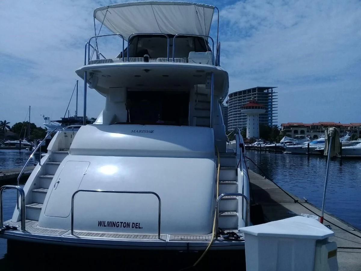 a large white boat in a harbor aboard LAZZARA 68' Yacht for Sale