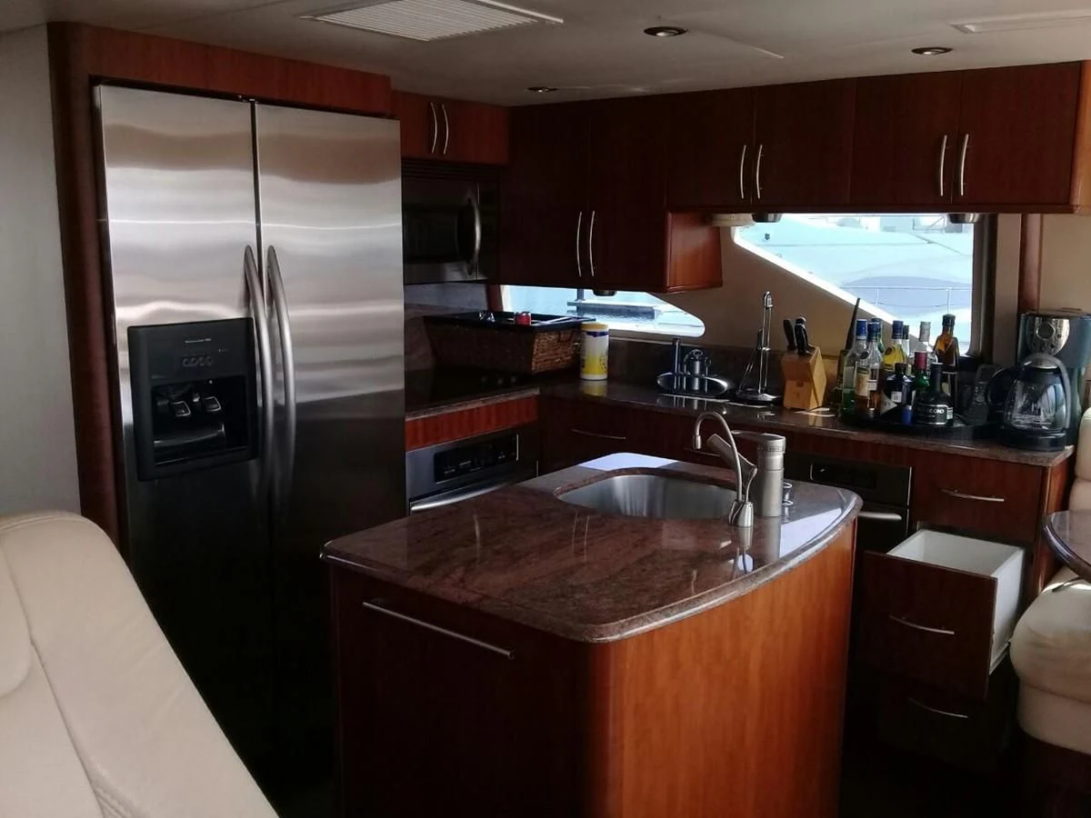a kitchen with a stainless steel refrigerator aboard LAZZARA 68' Yacht for Sale