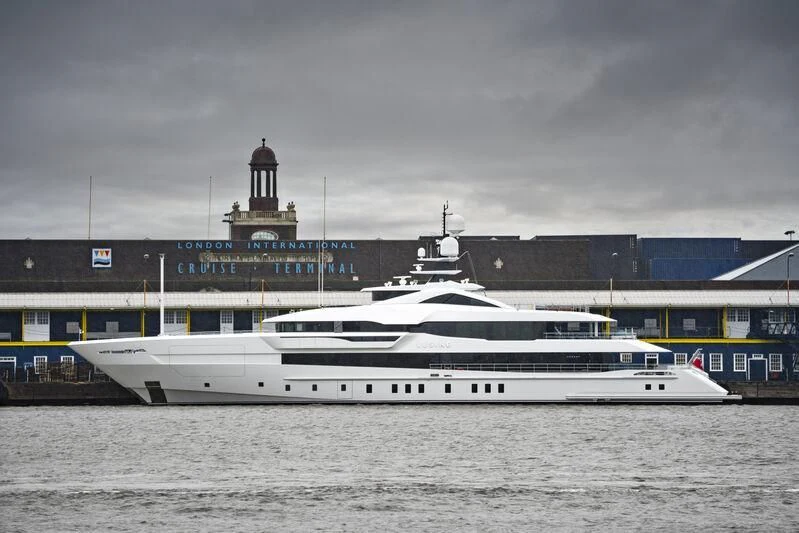 a large white boat in a harbor aboard LUSINE Yacht for Sale