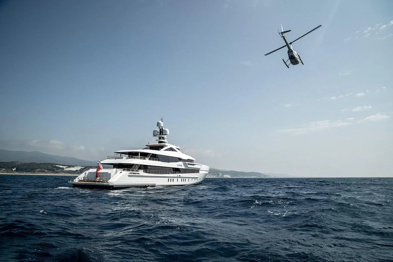 a helicopter flying over a boat in the water aboard LUSINE Yacht for Sale