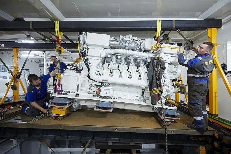a group of people working on a machine aboard LUSINE Yacht for Sale