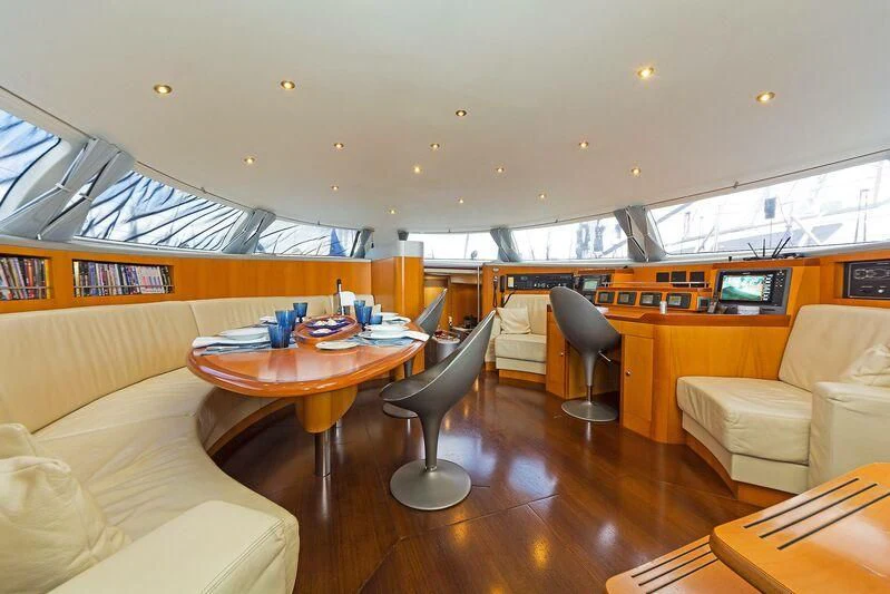 a room with a table and chairs aboard MELITI Yacht for Sale