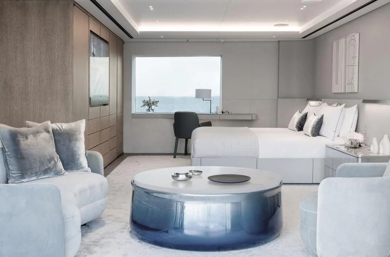 a living room with a round table aboard ENTOURAGE Yacht for Sale