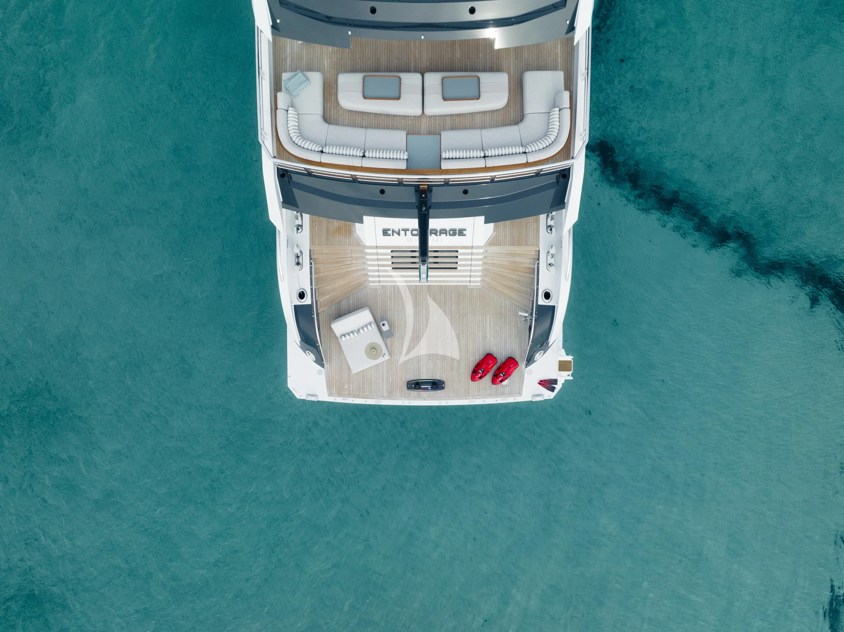 a small white and black toy car on a green surface aboard ENTOURAGE Yacht for Sale