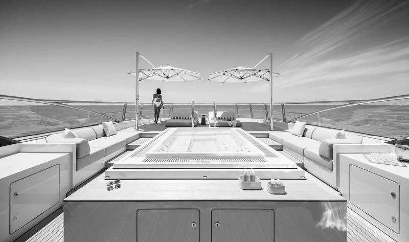 a large room with a table and chairs aboard ENTOURAGE Yacht for Sale