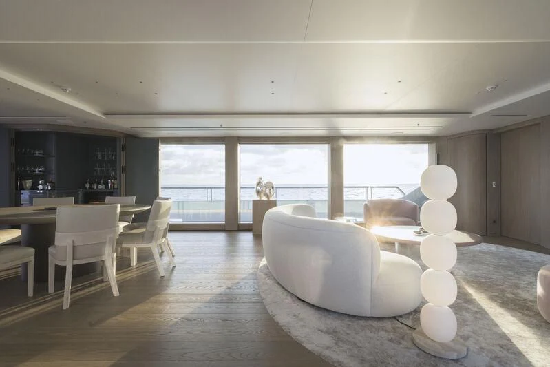 a room with a large window and a table with chairs and a large window aboard ENTOURAGE Yacht for Sale