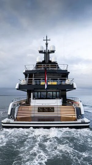 a ship in the water with Thomas Point Shoal Light in the background aboard ENTOURAGE Yacht for Sale