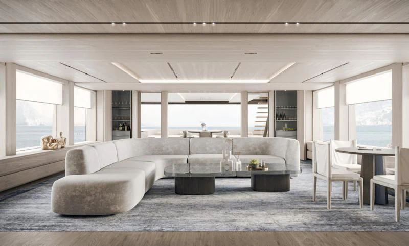 a living room with a large white sofa and a large window aboard ENTOURAGE Yacht for Sale