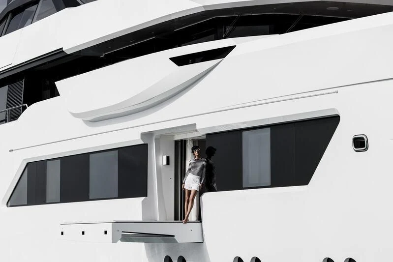 a couple of people standing in front of a white car aboard ENTOURAGE Yacht for Sale