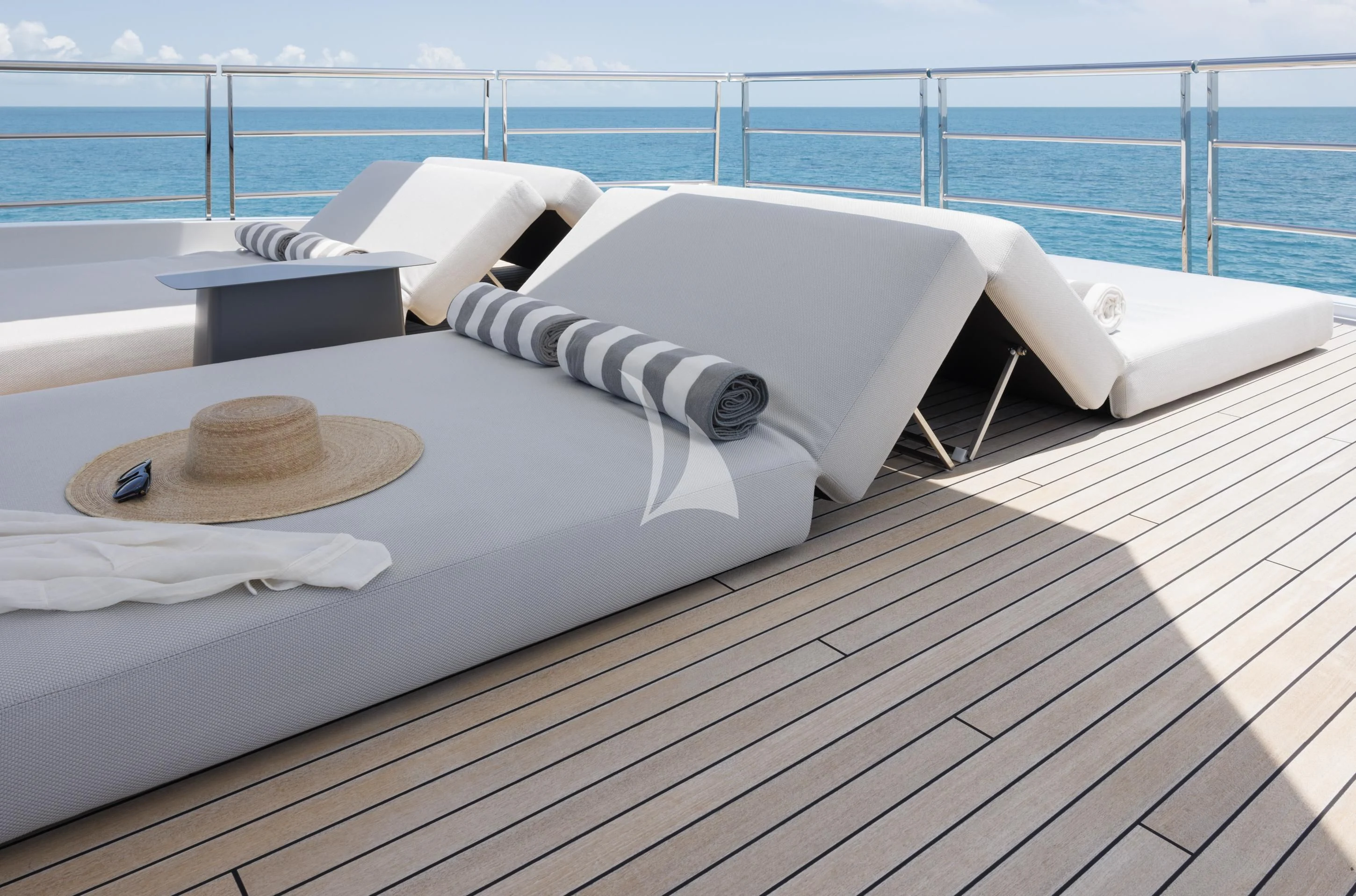 a white bed on a deck aboard ENTOURAGE Yacht for Sale