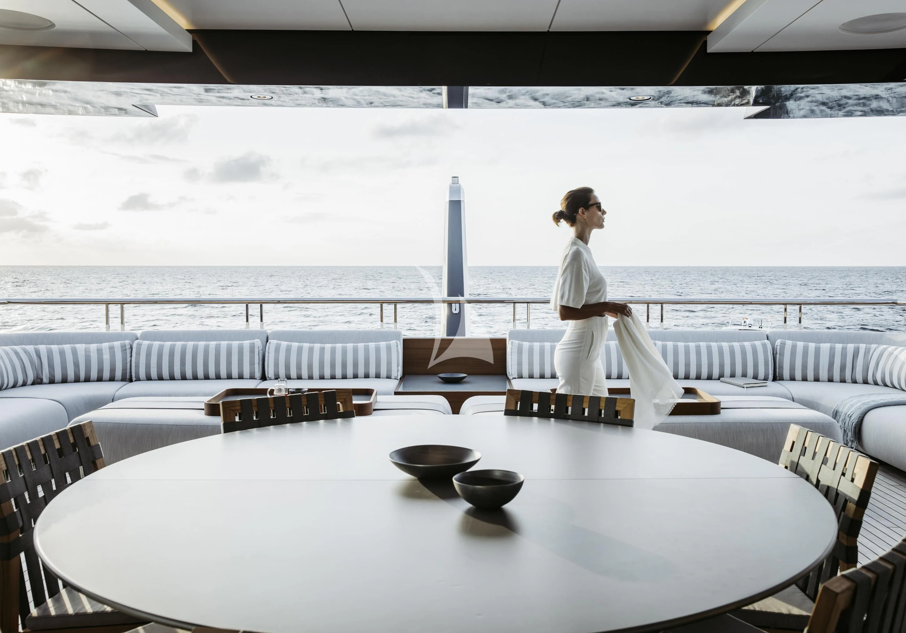 a person sitting on a table aboard ENTOURAGE Yacht for Sale
