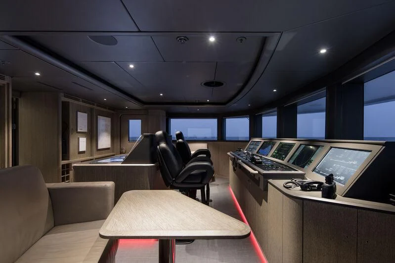 an office with a desk and chairs aboard ENTOURAGE Yacht for Sale