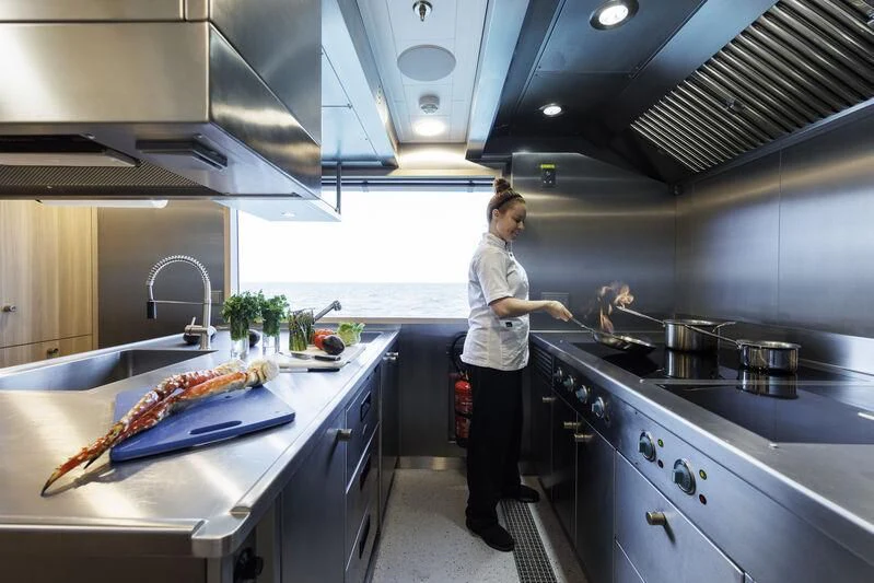 a person in a kitchen aboard ENTOURAGE Yacht for Sale