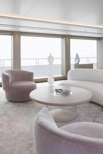 a living room with a table and chairs aboard ENTOURAGE Yacht for Sale