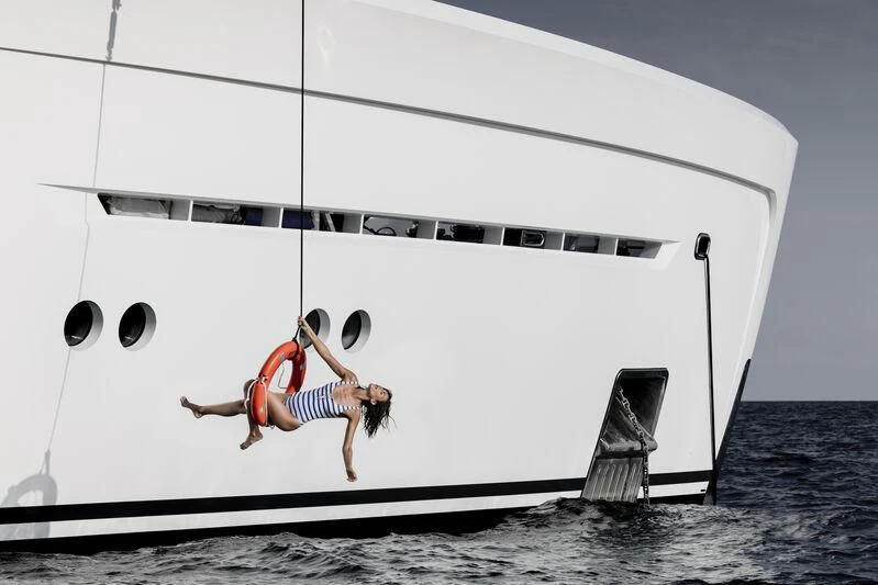 a person jumping from a boat aboard ENTOURAGE Yacht for Sale