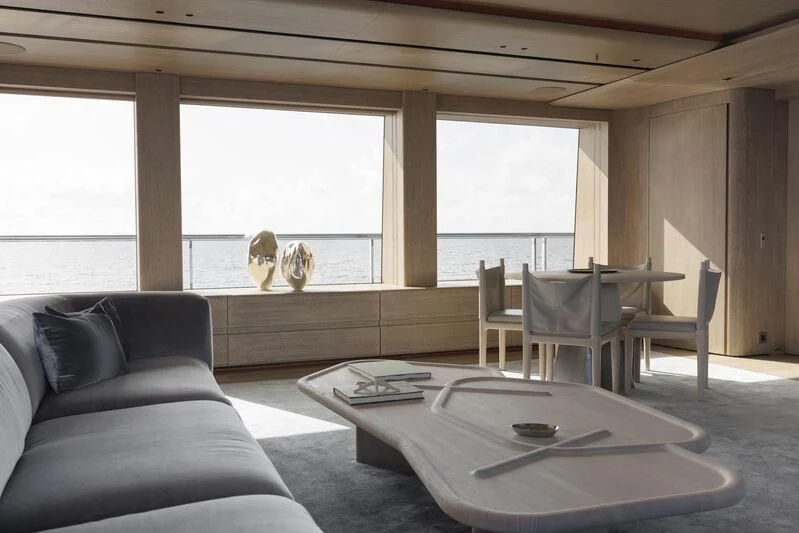a living room with a couch and a coffee table aboard ENTOURAGE Yacht for Sale