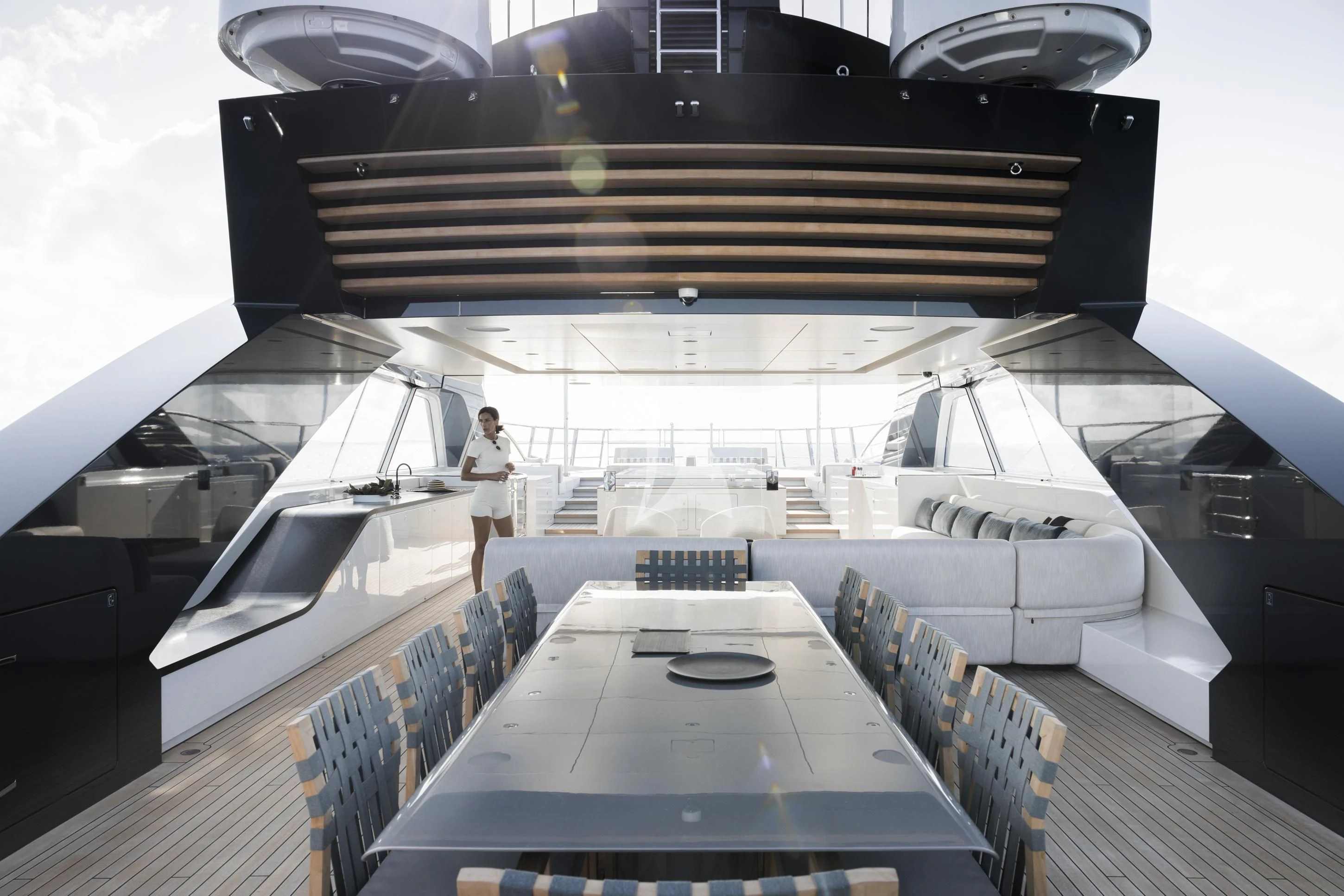 a person standing on a deck of a building aboard ENTOURAGE Yacht for Sale