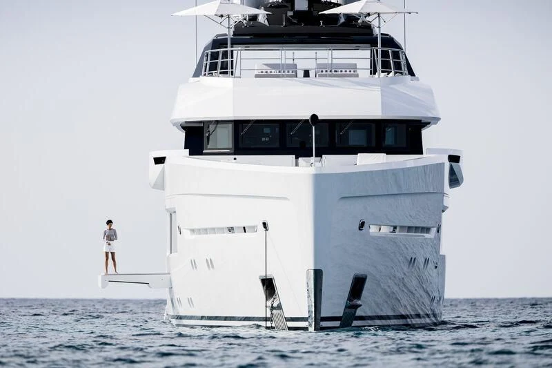 a person standing on a boat aboard ENTOURAGE Yacht for Sale