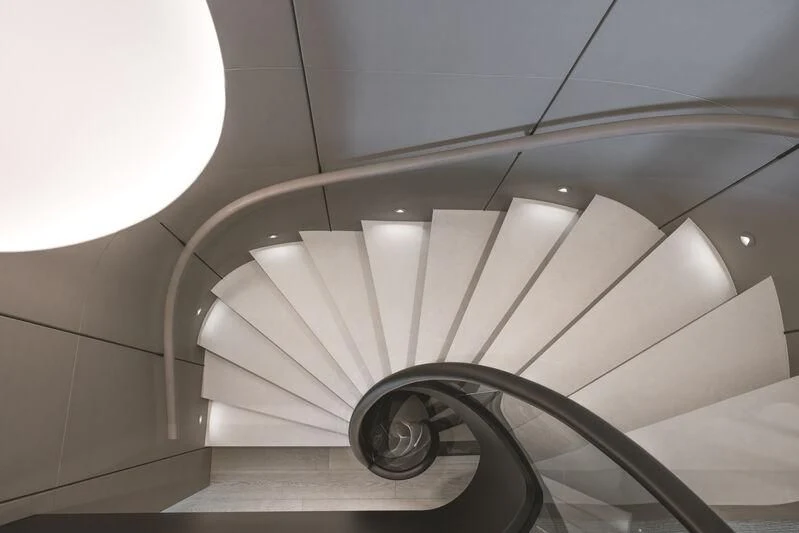 a white staircase with a spiral staircase aboard ENTOURAGE Yacht for Sale