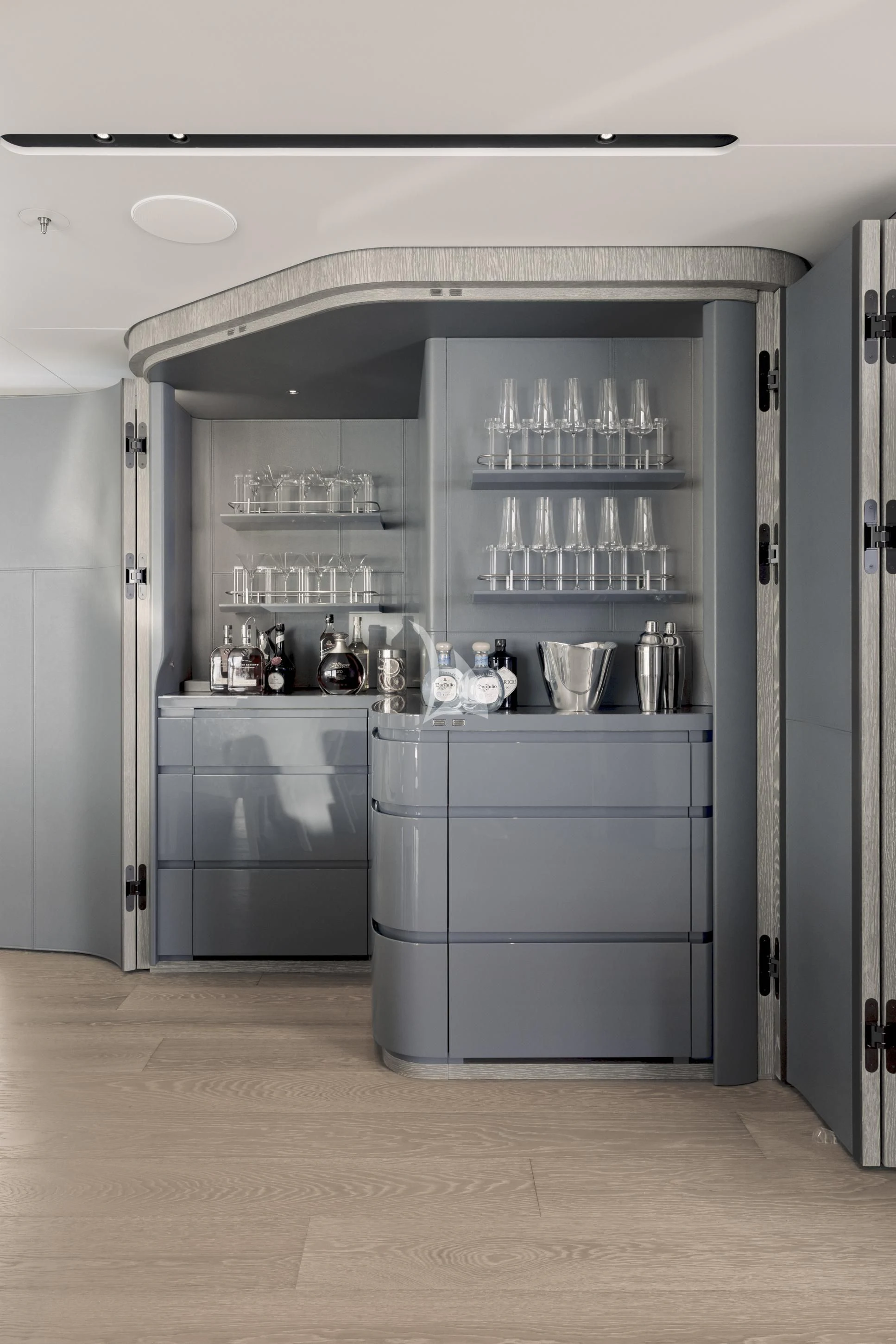a kitchen with a fridge and glasses aboard ENTOURAGE Yacht for Sale