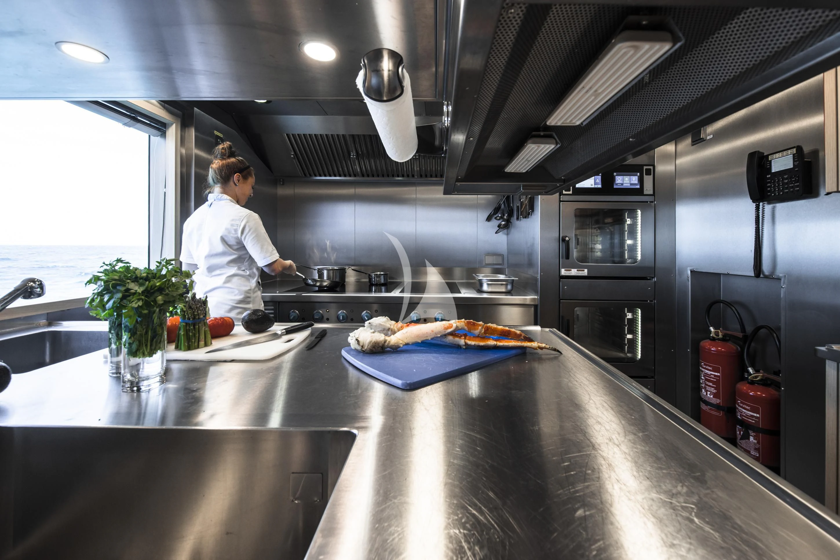 a chef in a kitchen aboard ENTOURAGE Yacht for Sale