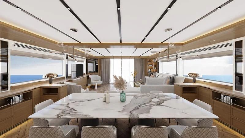 a large room with a large table and chairs aboard DESTINATION ONE Yacht for Sale