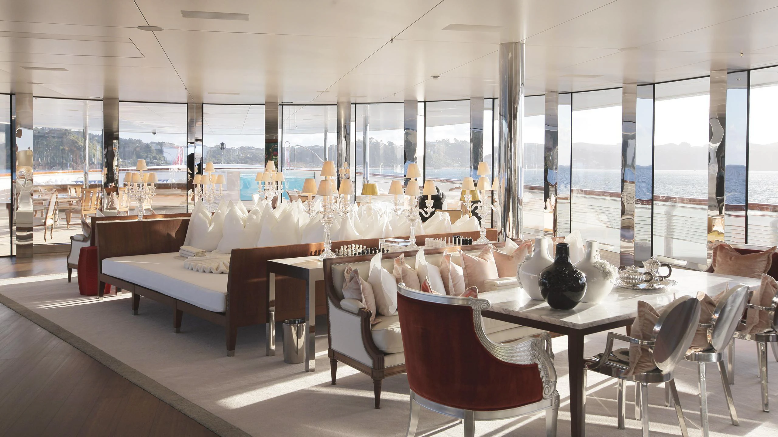 a room with tables and chairs aboard A Yacht for Sale