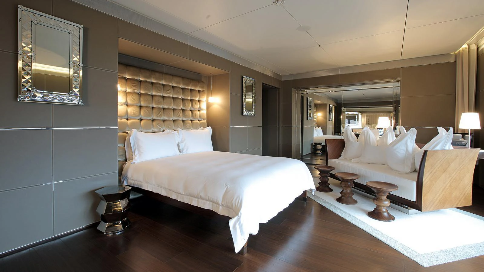 a room with a bed and a mirror aboard A Yacht for Sale