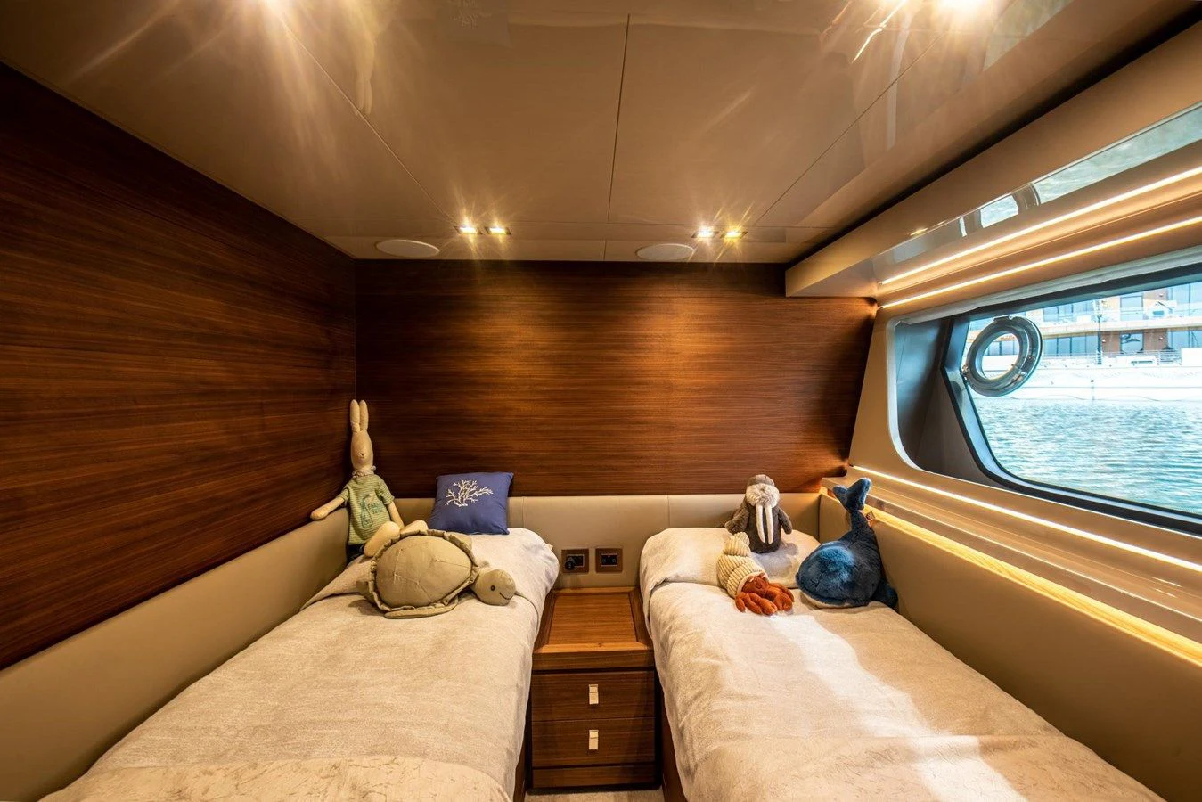 a couple of stuffed animals on a bed in a room aboard ZEN Yacht for Sale