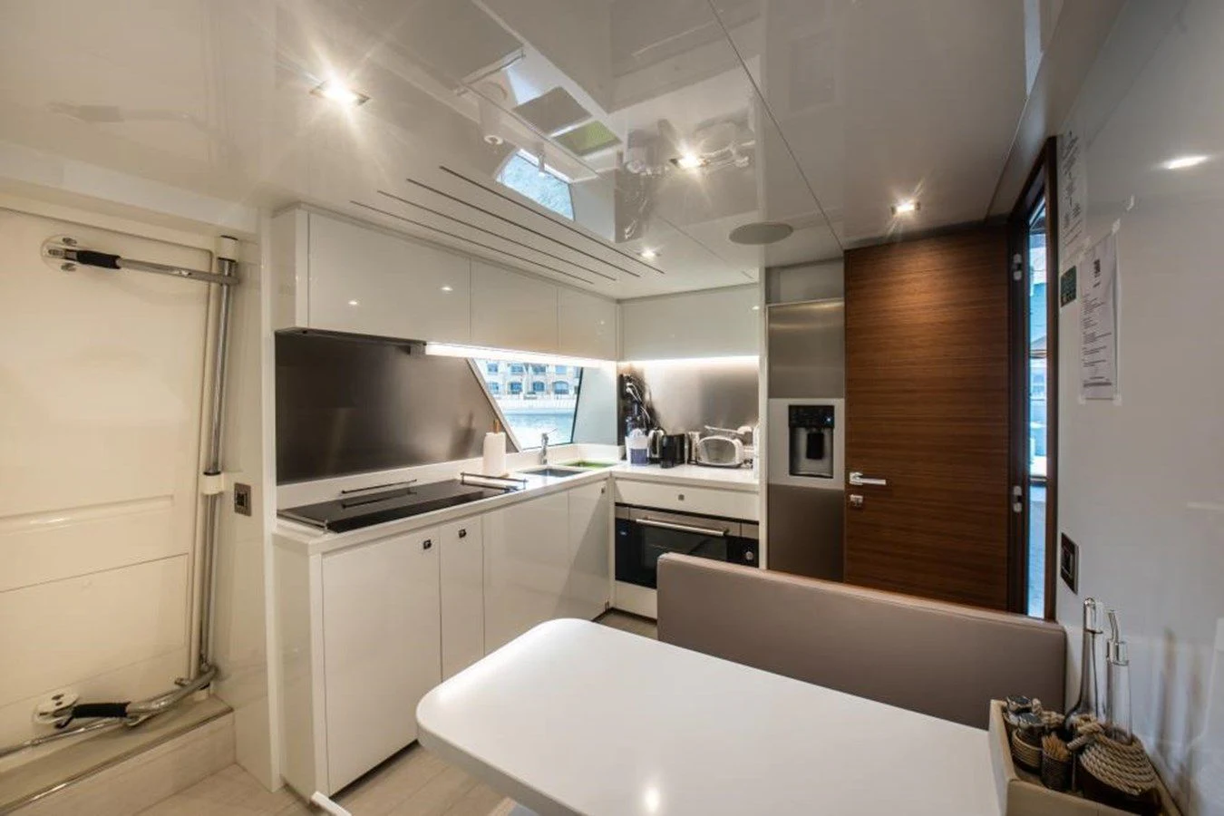a kitchen with a white table and white cabinets aboard ZEN Yacht for Sale