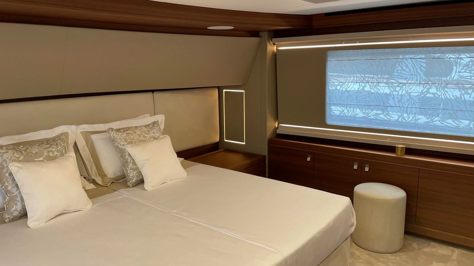 a bed with pillows and a window aboard ZEN Yacht for Sale