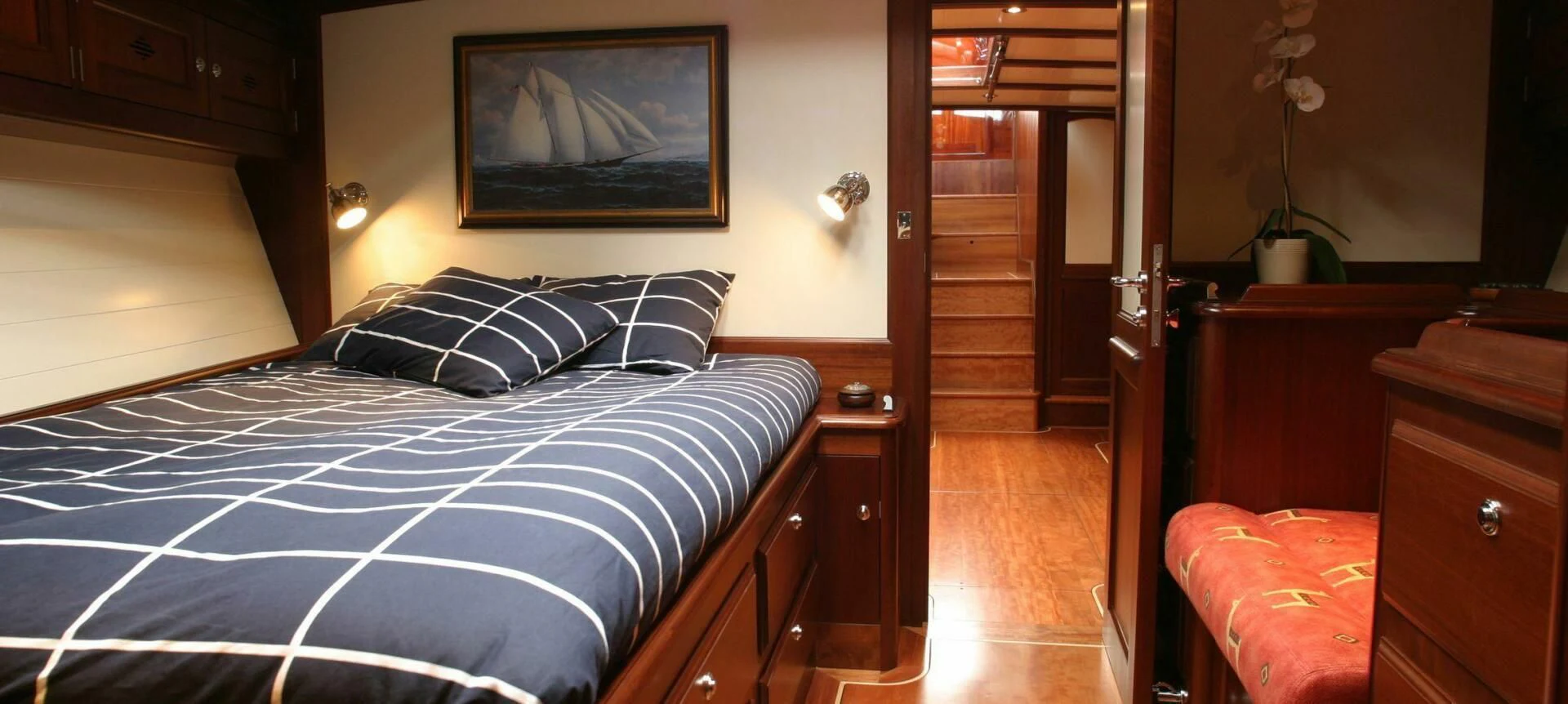 a bedroom with a bed and a television on the wall aboard ALDEBARAN Yacht for Sale