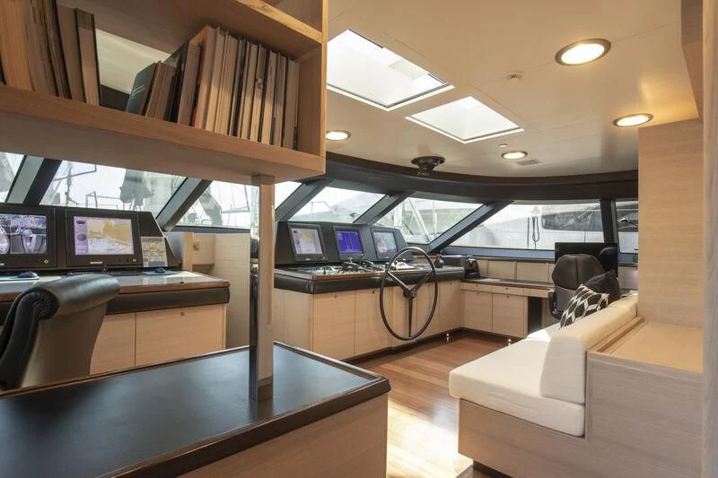 a room with a couch and a table with computers on it aboard CAOZ 14 Yacht for Sale
