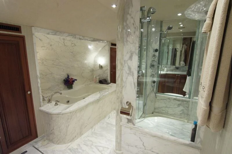 a bathroom with a tub and a shower aboard ANTARES Yacht for Sale