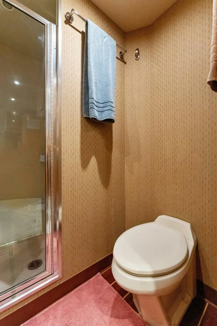 a bathroom with a toilet and a shower curtain aboard ANTARES Yacht for Sale