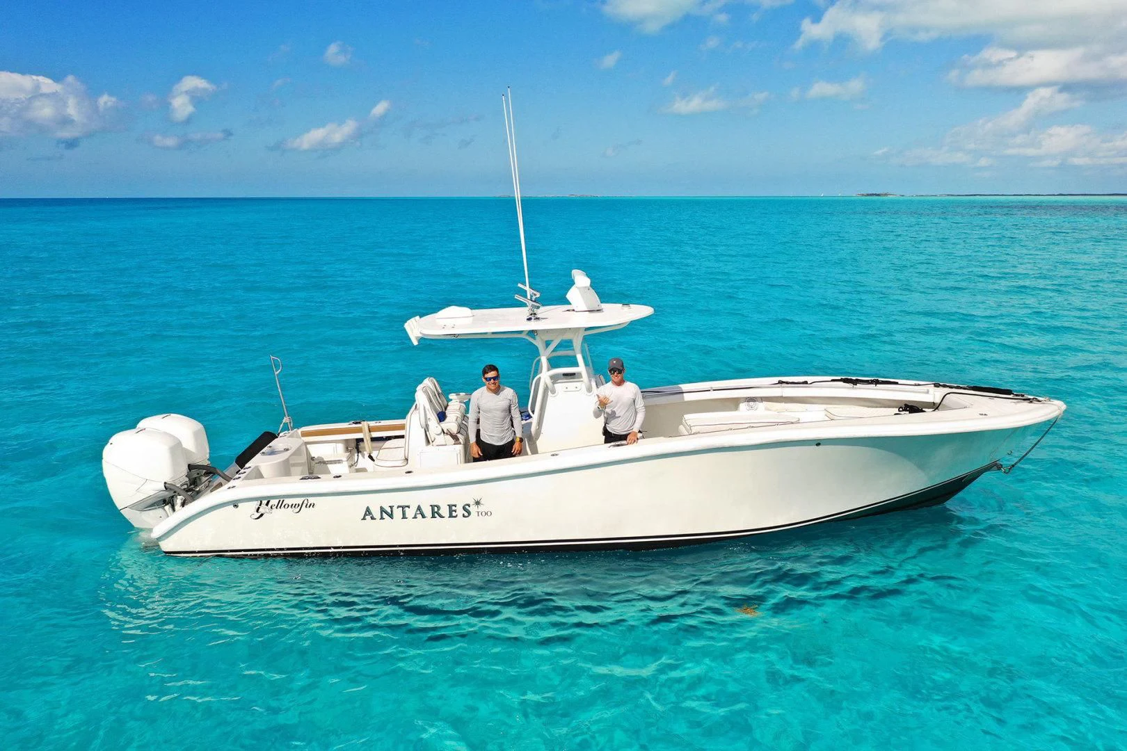 a couple of men on a white boat in the water aboard ANTARES Yacht for Sale