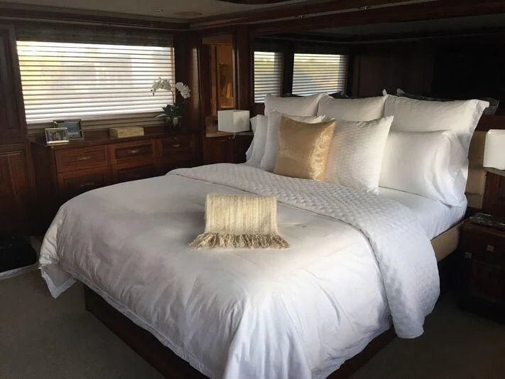 a large bed with white sheets aboard ANTARES Yacht for Sale