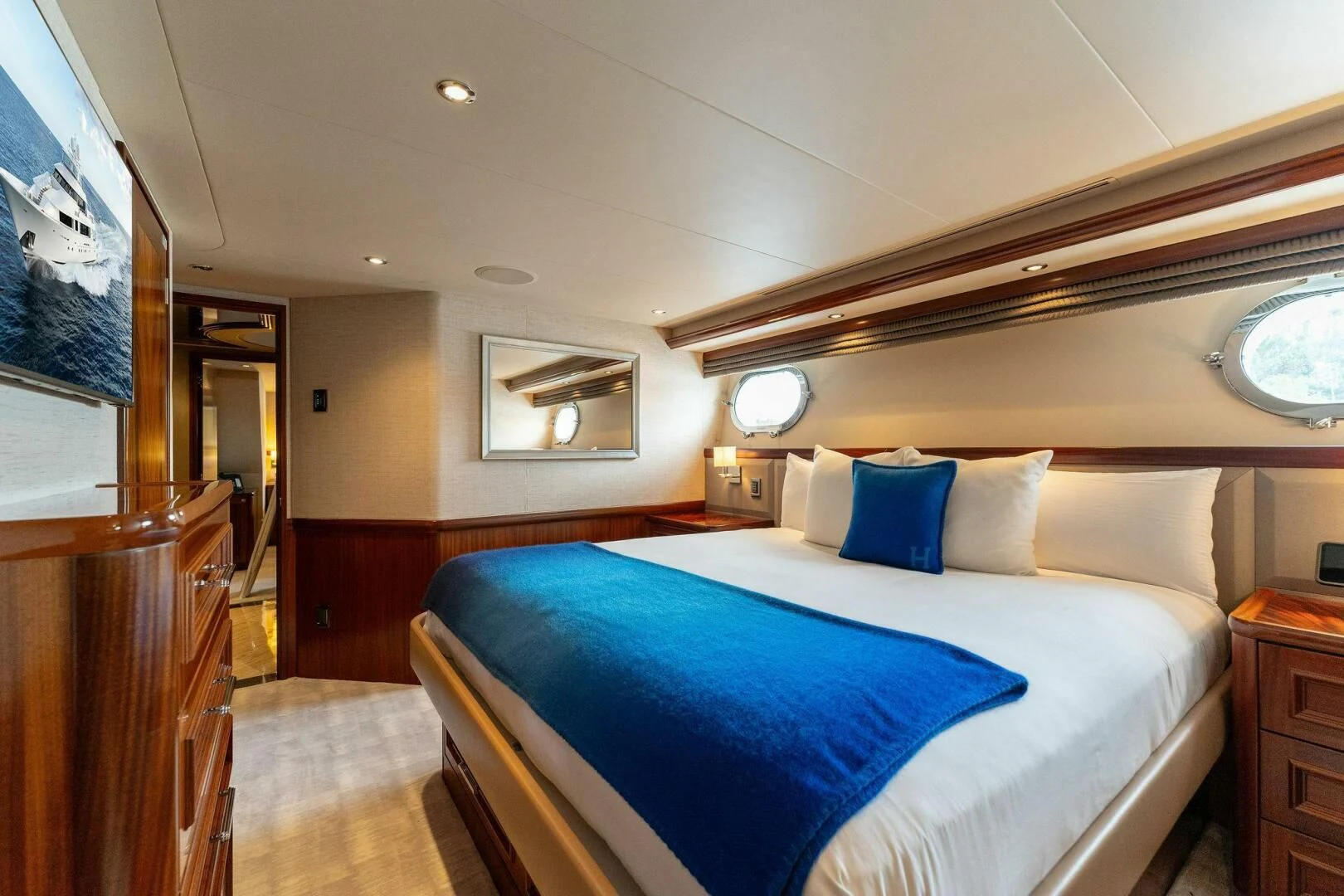 a bed with blue sheets aboard ANTARES Yacht for Sale