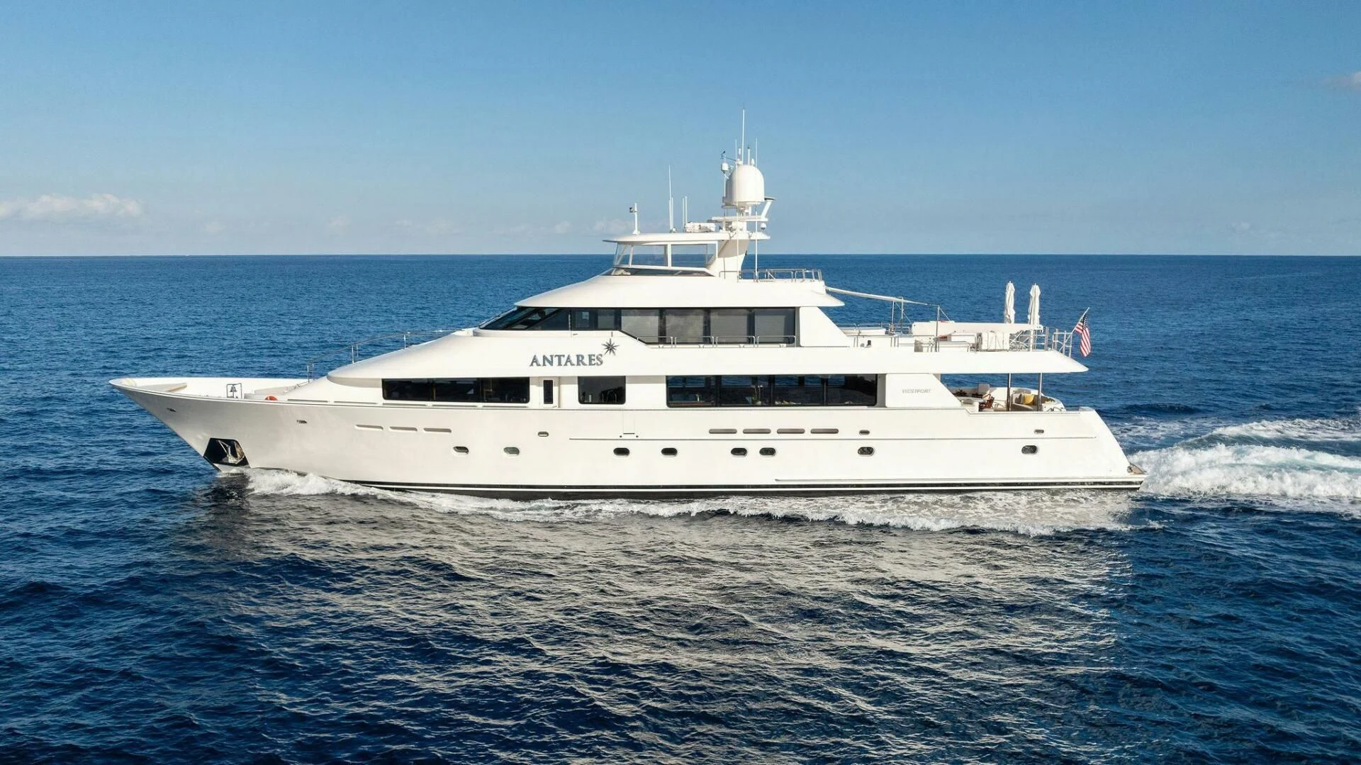 a white boat in the water aboard ANTARES Yacht for Sale