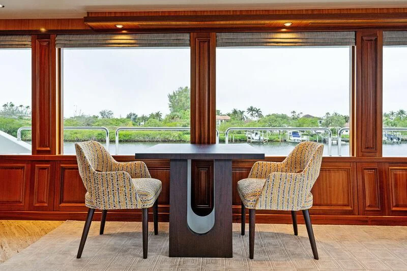 a table and chairs in a room aboard ANTARES Yacht for Sale